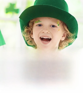 Detail of St. Patrick's Day clover and luck temporary face tattoos on a child model