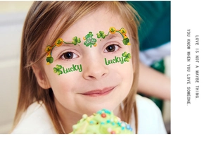 Close-up of St. Patrick's Day face tattoos featuring green shamrocks and lucky motifs
