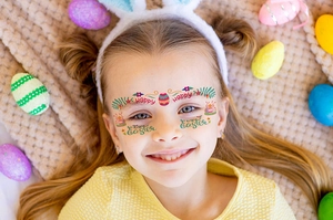 Détail de stickers visage de Pâques avec lapins et œufs colorés sur peau d'enfant