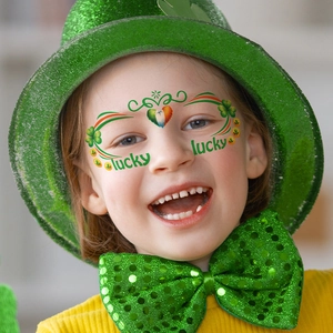 Saint Patrick's Day shamrock face tattoos with lucky text on a child's face