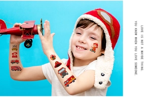 Close-up of waterproof fire truck temporary tattoos on a child's arm and face