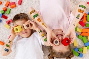 Kids wearing colorful sanitation and garbage truck temporary tattoos during playtime