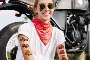 Kid temporary racing car tattoo on skin with cool red bandana and motorbike background