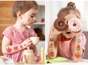 Close-up of kids waterproof cartoon afternoon tea tattoos with cake and tea cup designs