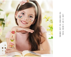 Detail of colorful children's temporary tattoos featuring cupcakes and floral designs
