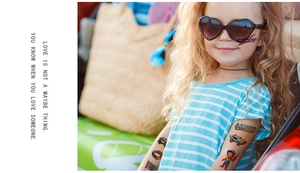 Detailed view of colorful cartoon racing car temporary tattoos on a child's arm and face