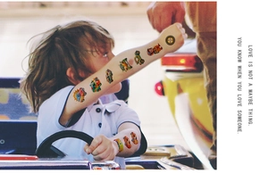 Close-up of waterproof cartoon racing car temporary tattoos applied on a child's arm
