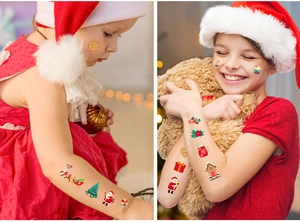 Close-up of children wearing Christmas tattoos with Santa and reindeer on their arms