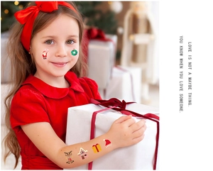 Detail of colorful Christmas cartoon temporary tattoos on a child's hand for festive party