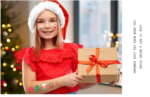 Detailed view of Christmas temporary tattoos with Santa and reindeer on child's face