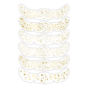 Macro detail of six metallic gold face tattoo stickers with star and floral patterns
