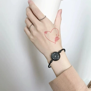Vintage small round black dial watch with woven strap and minimalist metal rings