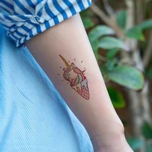 Cute rainbow unicorn ice cream temporary tattoo sticker for kids on arm with vibrant colors