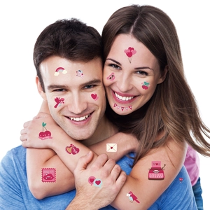 Romantic temporary tattoo stickers with hearts and colorful designs on model's face and arms