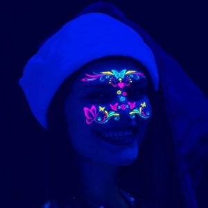 Neon butterfly glow face stickers for festivals and parties showing UV light effect