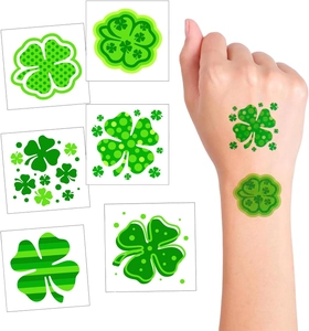 Detail of St. Patrick's Day green clover temporary tattoos shown on hand and sheet