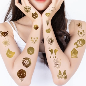 Golden metallic animal and celestial temporary tattoos set on model's arms and hands