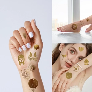 Close-up of metallic gold temporary tattoos featuring sun and moon patterns on skin