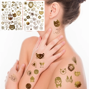 Detail of metallic gold temporary tattoos with lion and moon designs on skin