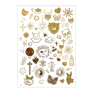 Macro view of gold metallic temporary tattoo sheet with lion, sun, and heart patterns