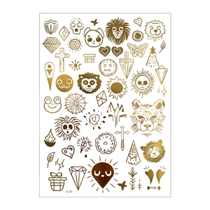 Macro view of gold metallic temporary tattoos with lion, sun and moon bohemian designs