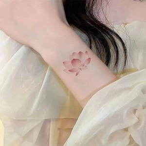 Waterproof lotus flower tattoo sticker with pink gradient design on woman's wrist
