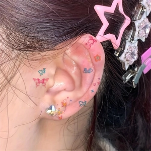 Colorful dopamine-style temporary ear tattoos with butterfly and star designs for women