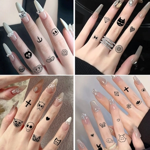 Minimalist black finger tattoo stickers with skulls, butterflies, and small heart patterns