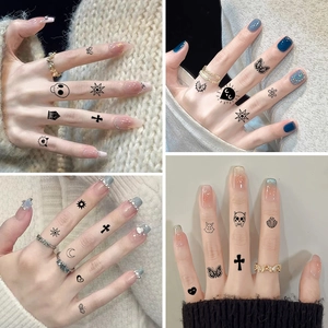 Minimalist black finger tattoo stickers with butterfly and cross designs on hands