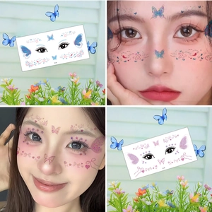 Colorful glitter butterfly face tattoos with heart patterns in blue and pink shades