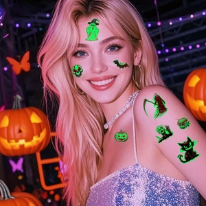 Luminous Halloween tattoos with green glow ghosts and pumpkins on female model face