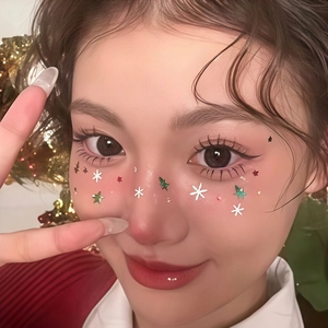 Christmas facial tattoo stickers with white snowflakes and green stars on female face