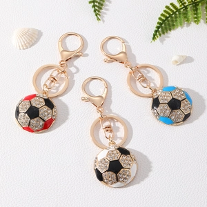 Sparkling rhinestone soccer keychains in red, blue, and black on a white textured background