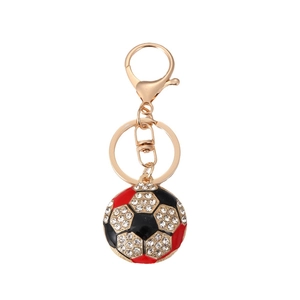 Golden sparkling rhinestone soccer ball keychain with red and black enamel detail