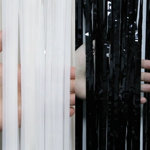 Detail of semi-transparent white and shiny black fringe curtains for football party decor