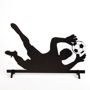 Macro detail of the goalkeeper silhouette wooden desk decor with football stand