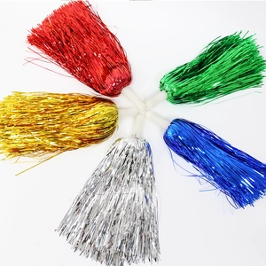 Detail of five colorful metallic cheerleading pom poms with ergonomic white handles