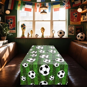 Detail of soccer themed table runner with green grass pattern and classic football print