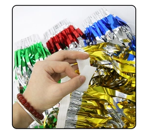 Close-up of the adhesive tape on top of colorful metallic foil fringe curtains for party