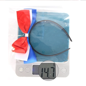 Weight measurement of 14.7g for a red, white, and blue satin bow headband accessory