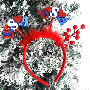 Close-up of USA headband with blue glitter stars and red berries on a snowy pine branch