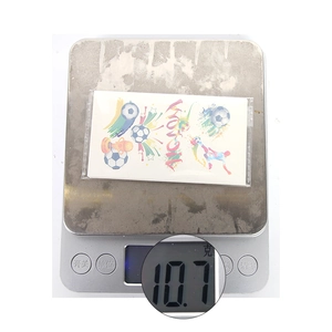 Detail shot of football World Cup themed temporary stickers weighing 10.7g on a scale