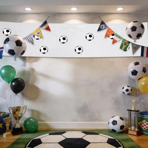 Close-up of soccer party set with national flags, trophy props and football balloons