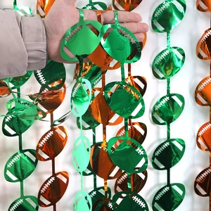 Green and orange football foil fringe curtains for sports themed birthday party decorations