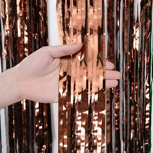 Detail of rose gold foil fringe curtain with metallic reflective texture for party decor