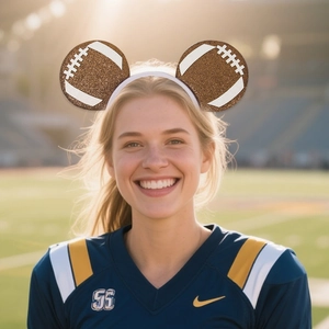 Detail of American football themed glitter ear headband worn by a model on a field
