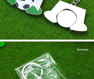 Close-up of metal football keychains on green turf and their clear OPP bag packaging