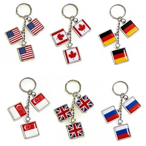 Detail of six metal national flag keychains including USA and UK with epoxy finish