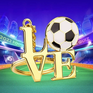 Gold metal football keychain with LOVE lettering and soccer ball on stadium background