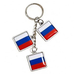 Detail of silver keychain with three Russia flag charms in glossy glass finish